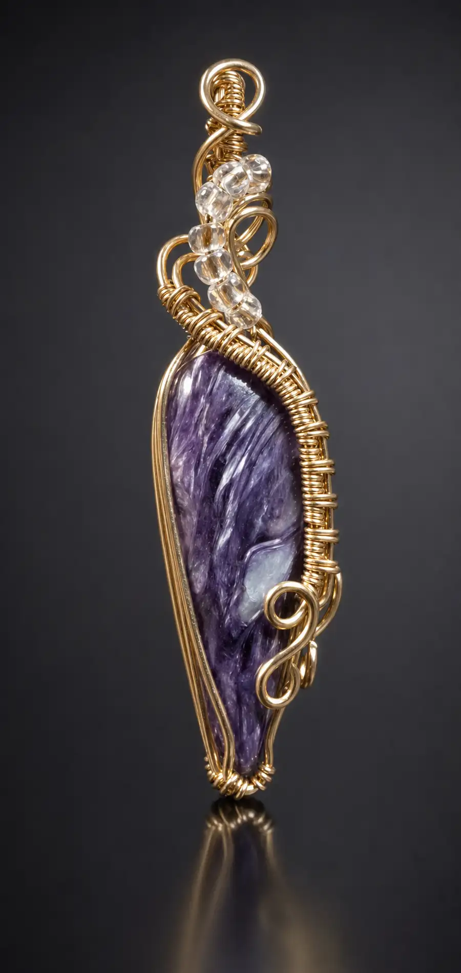 Wire-wrapped purple charoite pendant with clear quartz beads in gold wire